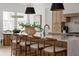 Open kitchen design with white quartz countertops, a modern faucet and four counter chairs at 440 Capri Ne Way, St Petersburg, FL 33704