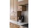 Close-up on wood cabinets, marble counters, and decor of the gourmet kitchen space at 440 Capri Ne Way, St Petersburg, FL 33704