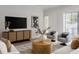 Bright living room with sleek console, modern art, and cozy seating area at 440 Capri Ne Way, St Petersburg, FL 33704