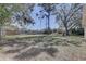 Large, partially shaded backyard features a wooden fence and lots of space for outdoor activities at 4750 Keysville Ave, Spring Hill, FL 34608