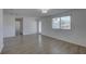 Bright living room featuring wood-look floors, a new window, and fresh neutral paint at 4750 Keysville Ave, Spring Hill, FL 34608