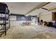 Spacious basement features concrete floors, a bicycle, and a white door to the exterior at 510 Pine S Ave, Oldsmar, FL 34677