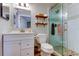 Well-lit bathroom boasts tiled shower, white cabinets and vanity, plus wood-look vinyl flooring at 510 Pine S Ave, Oldsmar, FL 34677