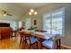 Open dining area with vaulted ceiling, hardwood floors and shuttered windows providing an abundance of natural light at 510 Pine S Ave, Oldsmar, FL 34677