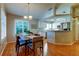 Bright dining area featuring hardwood floors, shutters, and open access to the modern kitchen at 510 Pine S Ave, Oldsmar, FL 34677