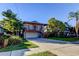 Charming two-story home featuring a spacious front porch, complemented by lush landscaping and a well-manicured lawn at 510 Pine S Ave, Oldsmar, FL 34677