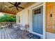 Inviting front porch with tongue and groove ceiling and ceiling fan, perfect for relaxing and enjoying the outdoors at 510 Pine S Ave, Oldsmar, FL 34677