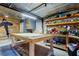 Roomy garage with high corrugated metal ceiling features large workbench, shelves, and pegboards at 510 Pine S Ave, Oldsmar, FL 34677