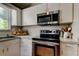 Well-equipped kitchen with stainless steel appliances, white cabinets, and ample counter space at 510 Pine S Ave, Oldsmar, FL 34677