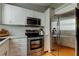 Well-equipped kitchen with stainless steel appliances, white cabinets, and plenty of storage space at 510 Pine S Ave, Oldsmar, FL 34677
