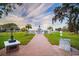 Brick walkway leading to a Veterans memorial surrounded by manicured lawn and shady trees at 510 Pine S Ave, Oldsmar, FL 34677