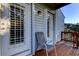 Cozy patio features chair, outdoor lighting, and white doors to the home's interior at 510 Pine S Ave, Oldsmar, FL 34677
