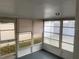 Enclosed sunroom featuring tiled floors and multiple windows at 5253 Falcon Dr, Holiday, FL 34690