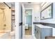 Stylish bathroom featuring a shower-tub combo, open shelves and a modern vanity sink at 5411 Starling Ridge Dr, Lithia, FL 33547