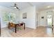 Open-concept dining room with modern furnishings, decorative lighting, and a view of the front entryway at 5411 Starling Ridge Dr, Lithia, FL 33547