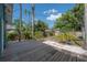 A serene backyard featuring a spacious wooden deck and lush greenery at 5603 N Taliaferro Ave, Tampa, FL 33604