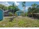 A well-maintained backyard with lush green grass and mature trees at 5603 N Taliaferro Ave, Tampa, FL 33604