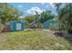 A well-maintained backyard with a storage shed and mature trees at 5603 N Taliaferro Ave, Tampa, FL 33604