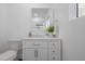 Well-lit bathroom with white vanity, toilet, decorative accents, and modern finishes at 5603 N Taliaferro Ave, Tampa, FL 33604