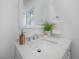 Bright, modern bathroom featuring a white vanity with elegant fixtures and patterned accents at 5603 N Taliaferro Ave, Tampa, FL 33604