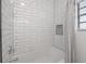 Modern bathroom with white subway tile shower, built-in niche, and clean, minimalist design at 5603 N Taliaferro Ave, Tampa, FL 33604