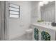 Well-lit bathroom with modern fixtures, patterned floor, and stylish vanity cabinet at 5603 N Taliaferro Ave, Tampa, FL 33604