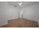 A bright bedroom featuring hardwood floors, white walls and trim at 5603 N Taliaferro Ave, Tampa, FL 33604