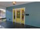 Close-up of the yellow front door framed by white trim, providing a pop of color and inviting entry at 5603 N Taliaferro Ave, Tampa, FL 33604