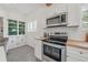 Modern kitchen has stainless steel appliances and ample countertop space at 5603 N Taliaferro Ave, Tampa, FL 33604
