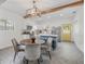 The well-lit kitchen features an island, stainless steel appliances, and a dining table at 5603 N Taliaferro Ave, Tampa, FL 33604