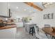 Bright kitchen features an island with barstool seating and stainless steel appliances at 5603 N Taliaferro Ave, Tampa, FL 33604