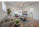 Open-concept living room with hardwood floors, neutral decor, and seamless flow to the dining area at 5603 N Taliaferro Ave, Tampa, FL 33604