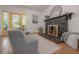 Living room showcases a stone fireplace, hardwood floors, and comfortable seating near a bright, inviting entry at 5603 N Taliaferro Ave, Tampa, FL 33604
