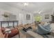 Spacious living room with hardwood floors, comfortable seating, and an open layout for entertaining at 5603 N Taliaferro Ave, Tampa, FL 33604