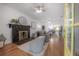 Open-concept living room with a stone fireplace, wood floors, and contemporary furnishings at 5603 N Taliaferro Ave, Tampa, FL 33604