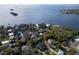 Scenic aerial view of waterfront homes surrounded by lush greenery and beautiful blue water at 613 Orange St, Palm Harbor, FL 34683