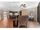 Bright and airy living room featuring hardwood floors, ceiling fan, and open layout to kitchen at 6208 Anhinga Pl, Tampa, FL 33615