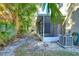 Private backyard showing lush green vegetation surrounding a screened in lanai and AC unit at 6255 Osprey Lake Cir, Riverview, FL 33578