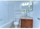 Bathroom featuring a tub, dark vanity, and decorative mirror at 6255 Osprey Lake Cir, Riverview, FL 33578