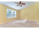 Cozy bedroom with a ceiling fan and a bright window providing natural light at 6255 Osprey Lake Cir, Riverview, FL 33578