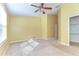 Open bedroom space featuring ceiling fan, window, and closet with shelving at 6255 Osprey Lake Cir, Riverview, FL 33578