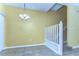 Bright dining room next to stairway has tile flooring and chandelier lighting at 6255 Osprey Lake Cir, Riverview, FL 33578