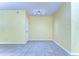 Bright, neutral room with tile flooring, recessed lighting, and a door, offers a versatile space for various uses at 6255 Osprey Lake Cir, Riverview, FL 33578
