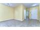 Spacious, light-filled room with tile flooring, white trim, and an entry door provides a flexible and adaptable space at 6255 Osprey Lake Cir, Riverview, FL 33578