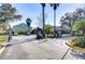 Gated community entrance with meticulously maintained landscaping and ample parking for residents and guests at 6255 Osprey Lake Cir, Riverview, FL 33578