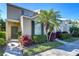 Charming two-story townhome featuring a manicured front yard, lush landscaping, and a welcoming front door at 6255 Osprey Lake Cir, Riverview, FL 33578