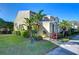 Inviting two-story home with lush tropical landscaping and well-manicured lawn at 6255 Osprey Lake Cir, Riverview, FL 33578