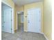 Inviting foyer with neutral-colored walls and tiled flooring, leading to various rooms at 6255 Osprey Lake Cir, Riverview, FL 33578