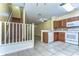 View of open floor plan with kitchen, stairway, and living room at 6255 Osprey Lake Cir, Riverview, FL 33578