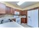 Kitchen features matching wood cabinetry and appliances on tile floor at 6255 Osprey Lake Cir, Riverview, FL 33578